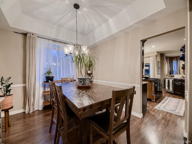 9412 Burgundy Cir, Highlands Ranch, CO 80126 - dining room with dark wood-type flooring, a chandelier, a tray ceiling, and wine cooler