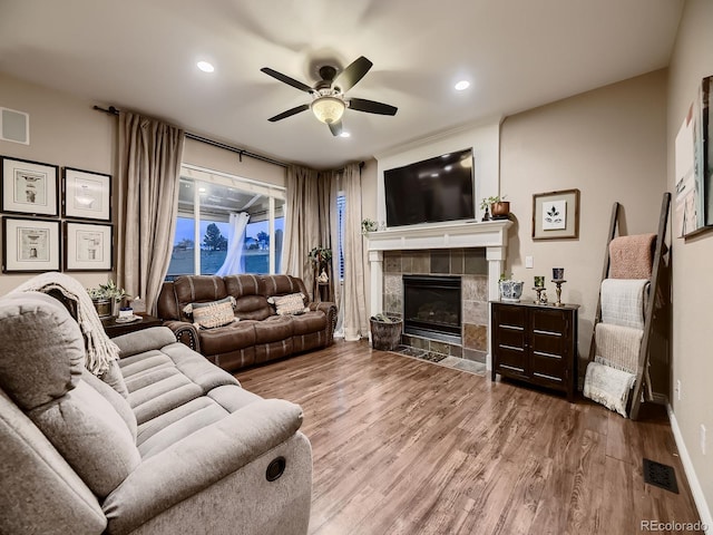 9412 Burgundy Cir, Highlands Ranch, CO 80126 - living room with wood finished floors, ceiling fan, recessed lighting, and a tiled fireplace