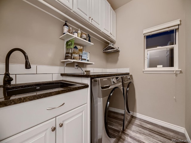9412 Burgundy Cir, Highlands Ranch, CO 80126 - washroom featuring independent washer and dryer, wood finished floors, and cabinet space