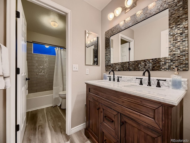 9412 Burgundy Cir, Highlands Ranch, CO 80126 - bathroom with wood finished floors, double vanity, and shower / tub combo with curtain