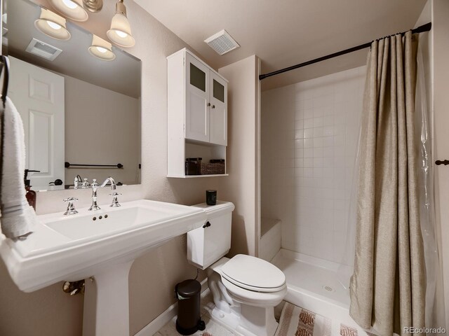 9412 Burgundy Cir, Highlands Ranch, CO 80126 - bathroom featuring toilet and a stall shower