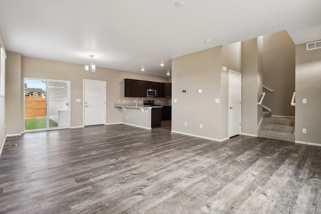 unfurnished living room with dark hardwood / wood-style floors