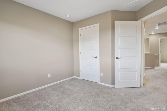 unfurnished bedroom with light colored carpet