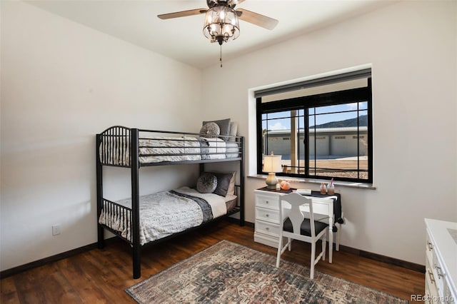 bedroom featuring baseboards and wood finished floors