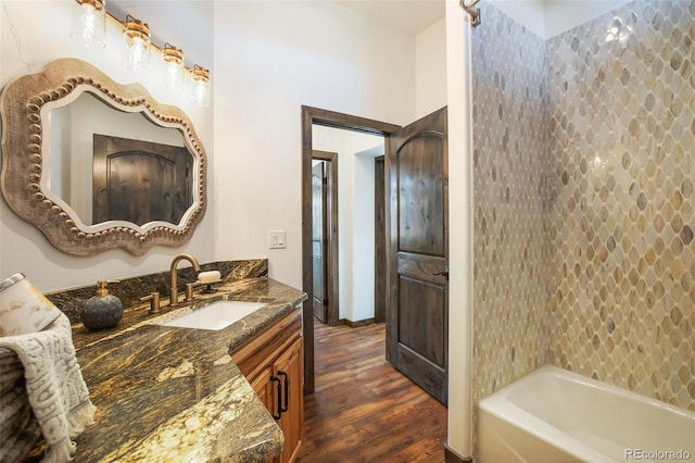 full bath featuring bathing tub / shower combination, vanity, and wood finished floors