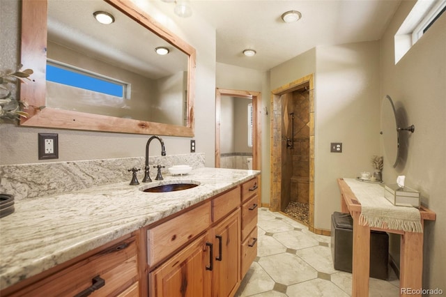 bathroom featuring a stall shower and vanity