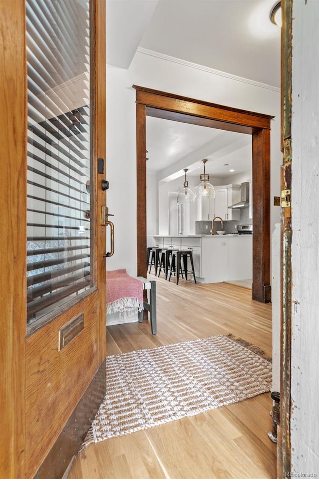 hall with crown molding and hardwood / wood-style floors