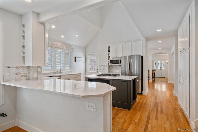 2340 S Columbine St, Denver, CO 80210 - kitchen featuring appliances with stainless steel finishes, arched walkways, open shelves, light countertops, and recessed lighting