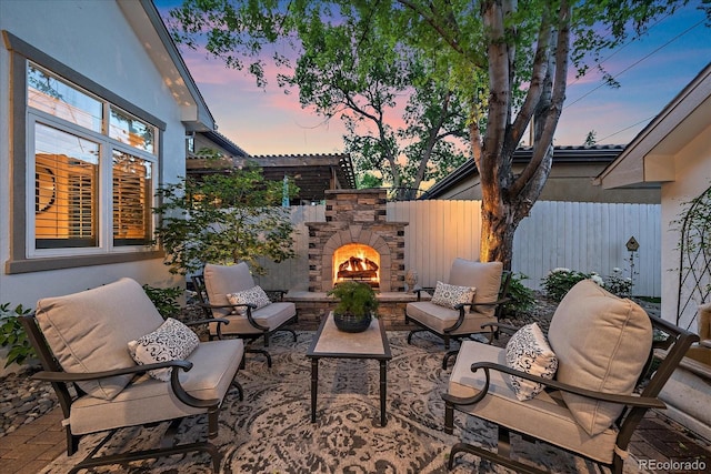 2340 S Columbine St, Denver, CO 80210 - patio terrace at dusk with an outdoor living space with a fireplace and a patio