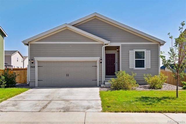 view of front of house featuring a front yard and a garage