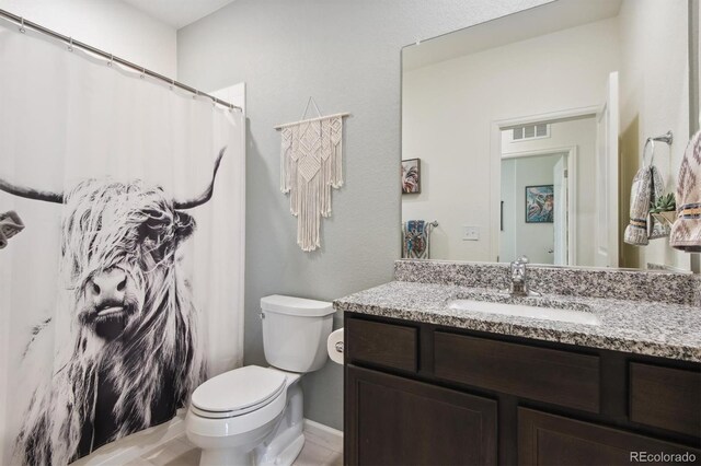 bathroom with vanity and toilet