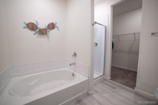 bathroom featuring hardwood / wood-style floors and independent shower and bath