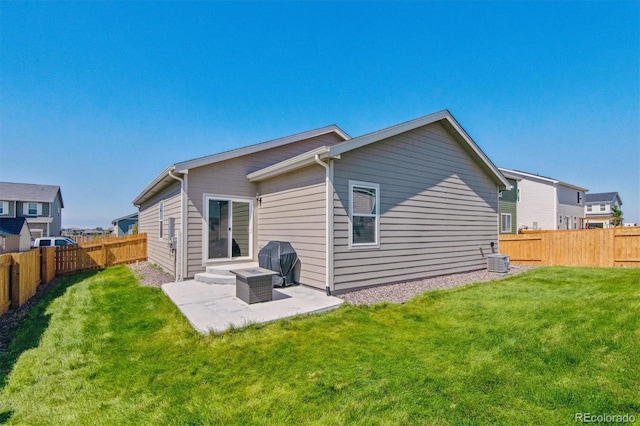 rear view of house featuring a patio, a yard, and cooling unit