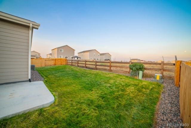 yard at dusk with a patio