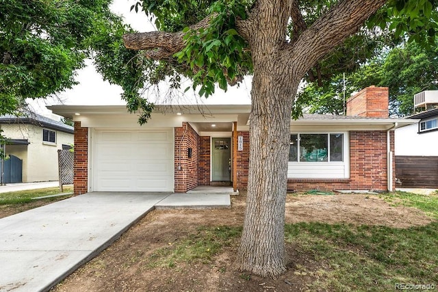 1815 S Monroe St, Denver, CO 80210 - single story home featuring brick siding, driveway, a chimney, and a garage