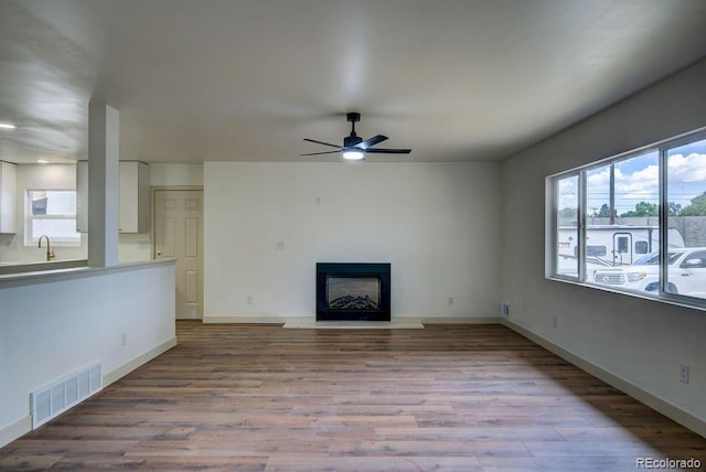 1815 S Monroe St, Denver, CO 80210 - unfurnished living room with ceiling fan, wood finished floors, and a fireplace