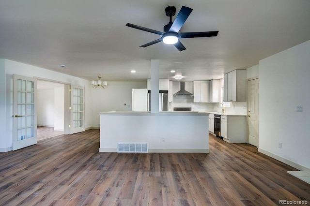 1815 S Monroe St, Denver, CO 80210 - kitchen with wall chimney exhaust hood, freestanding refrigerator, a chandelier, dishwashing machine, and dark wood finished floors