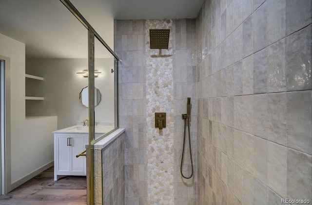 1815 S Monroe St, Denver, CO 80210 - bathroom with a tile shower, vanity, and wood finished floors