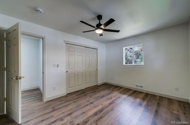 1815 S Monroe St, Denver, CO 80210 - unfurnished bedroom with wood finished floors, ceiling fan, and a closet