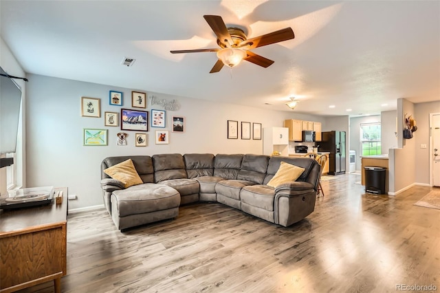 10700 Kimblewyck Cir Unit 155, Northglenn, CO 80233 - living room with a ceiling fan and light wood finished floors