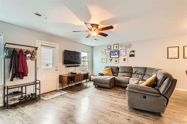 10700 Kimblewyck Cir Unit 155, Northglenn, CO 80233 - living room featuring a ceiling fan and light wood-style flooring