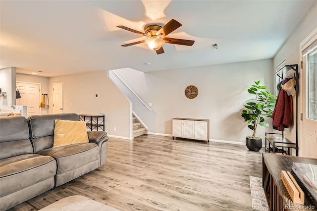 10700 Kimblewyck Cir Unit 155, Northglenn, CO 80233 - living area with stairs, a ceiling fan, and light wood finished floors