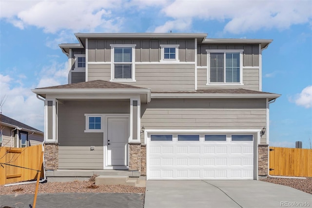 9456 Yampa Ct, Commerce City, CO 80022 - view of front of house with a garage, board and batten siding, stone siding, and fence