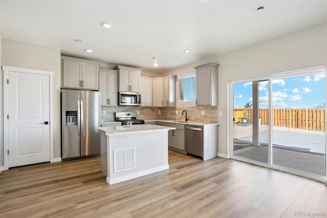 9456 Yampa Ct, Commerce City, CO 80022 - kitchen featuring visible vents, light countertops, appliances with stainless steel finishes, light wood-style floors, and gray cabinetry