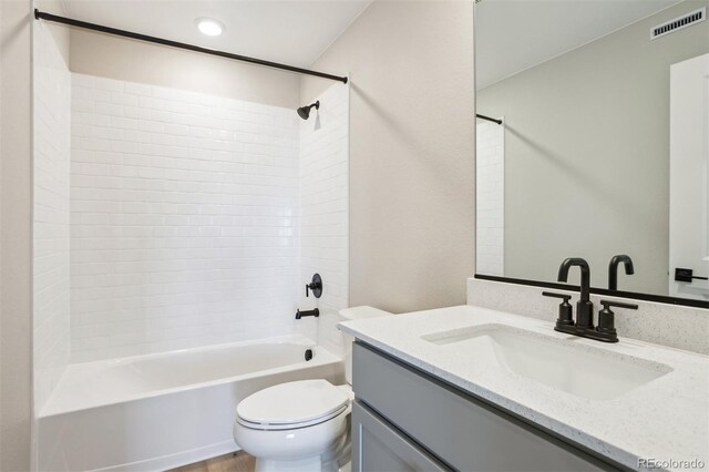9456 Yampa Ct, Commerce City, CO 80022 - full bath with washtub / shower combination, vanity, visible vents, and toilet
