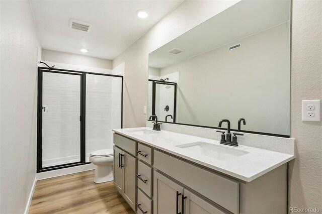 9456 Yampa Ct, Commerce City, CO 80022 - full bath with a shower stall, visible vents, a sink, and wood finished floors
