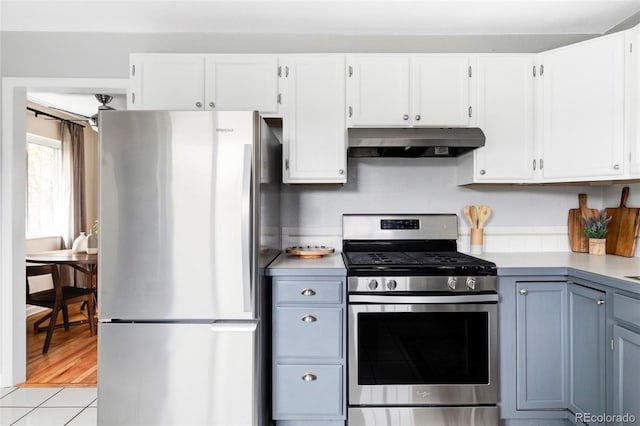 kitchen with light countertops, white cabinetry, appliances with stainless steel finishes, and under cabinet range hood