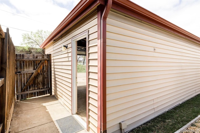view of outdoor structure featuring a gate and fence