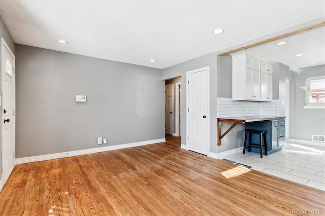 unfurnished living room featuring light wood-type flooring