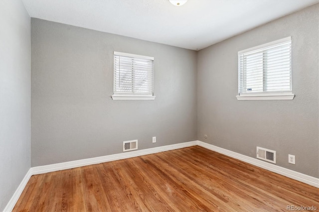 empty room with hardwood / wood-style flooring