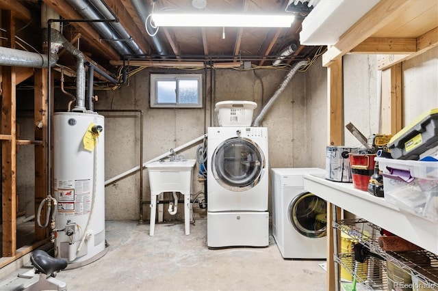 laundry room featuring gas water heater, sink, and independent washer and dryer