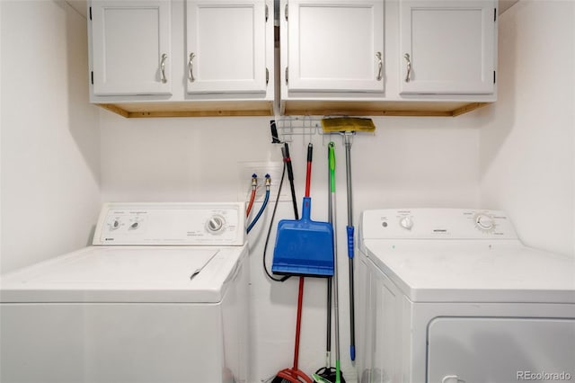 laundry room with washer and clothes dryer and cabinets