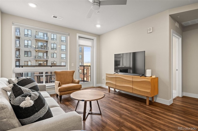 living area featuring baseboards, recessed lighting, and wood finished floors