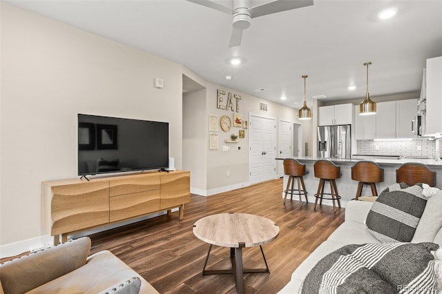 living room with ceiling fan, recessed lighting, baseboards, wood finished floors, and visible vents