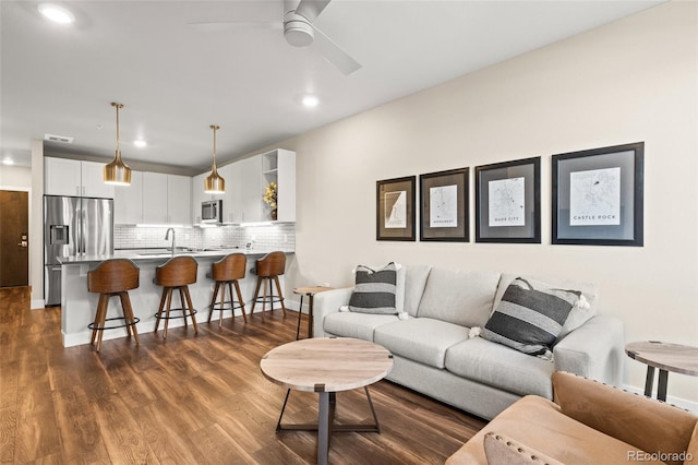 living room featuring a ceiling fan, dark wood finished floors, recessed lighting, and visible vents