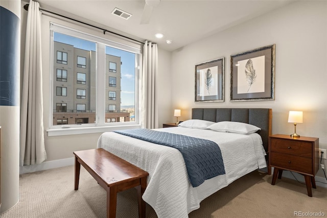 carpeted bedroom featuring baseboards and visible vents