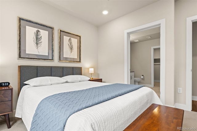 bedroom featuring baseboards, recessed lighting, and ensuite bath