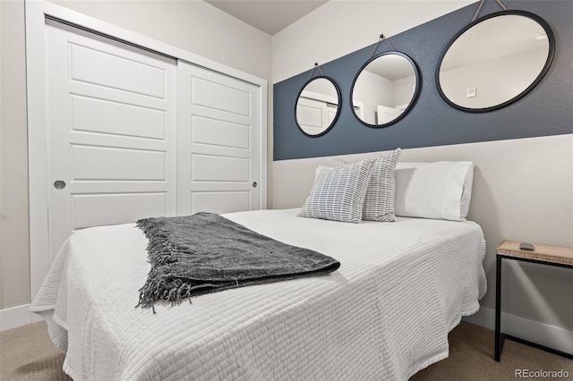 bedroom with carpet floors, baseboards, and a closet