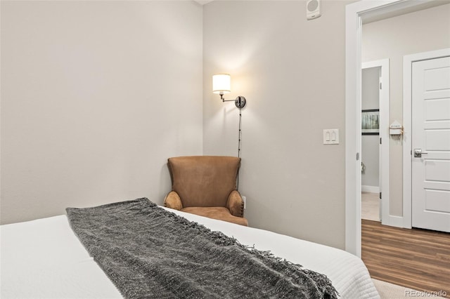 bedroom featuring baseboards and wood finished floors