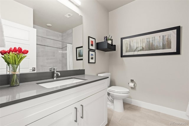 bathroom with visible vents, a tile shower, vanity, baseboards, and toilet
