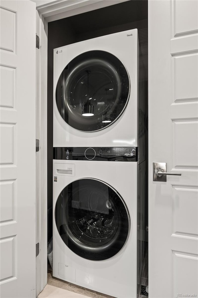 washroom with laundry area and stacked washer / dryer