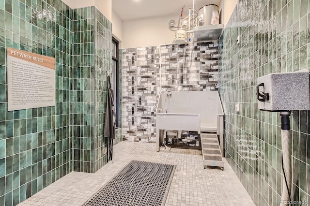 bathroom with tile patterned floors and tile walls