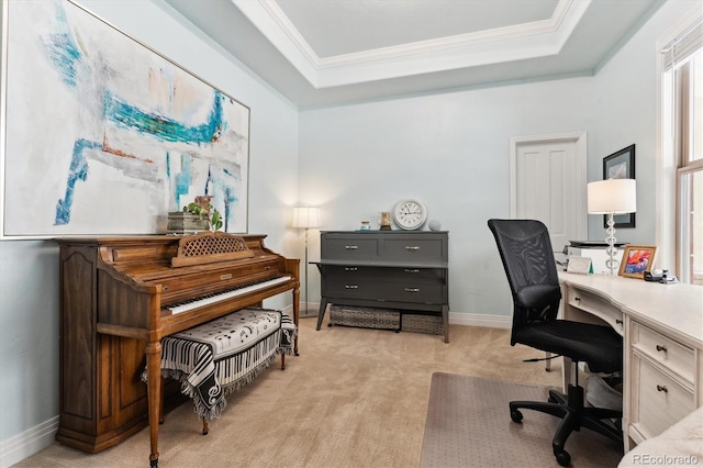 home office featuring ornamental molding, light carpet, and a tray ceiling