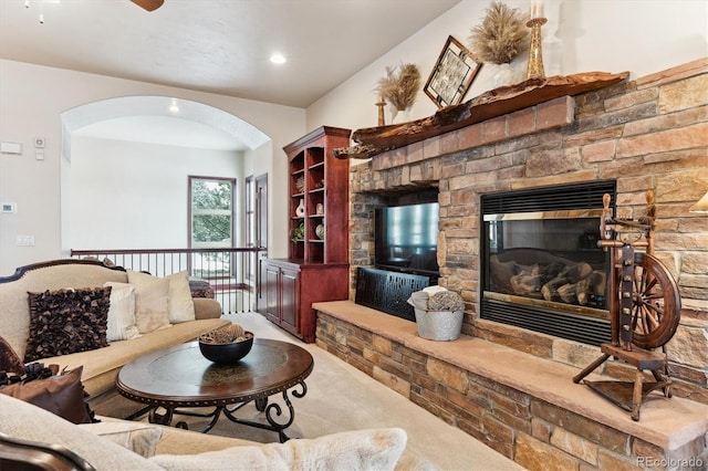 living room featuring light carpet and a fireplace