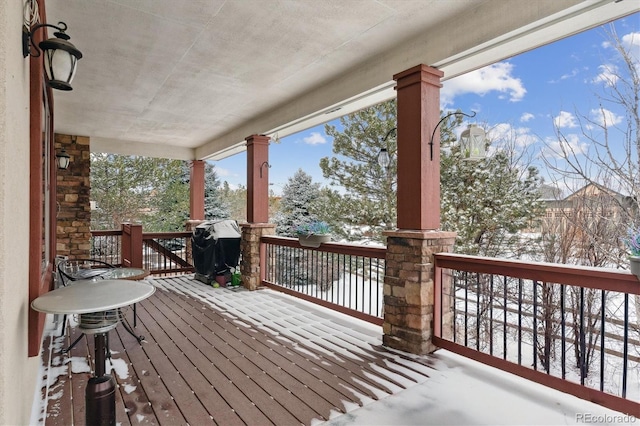 snow covered deck featuring a grill