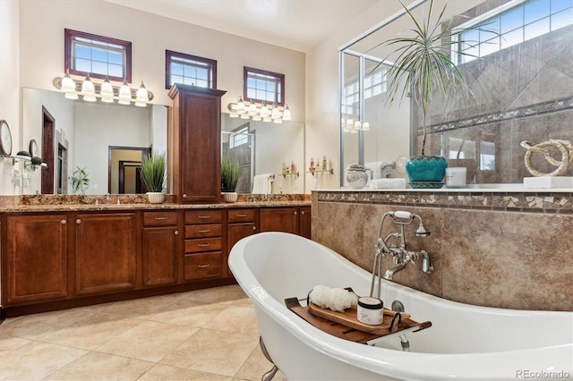 bathroom with tile patterned floors, vanity, and a tub